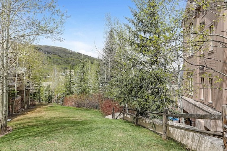 A large lawn looking out toward moutains in a Beaver Creek ski in ski out rental option.