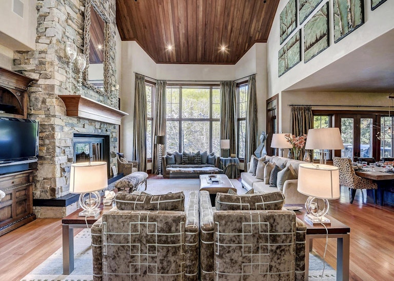 Lounge area with high ceilings and large windows in one of Beaver Creek's home rentals