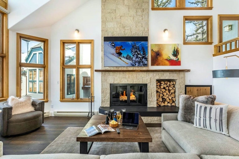 Cozy Beaver Creek home rental with fireplace, sofa and coffee table.