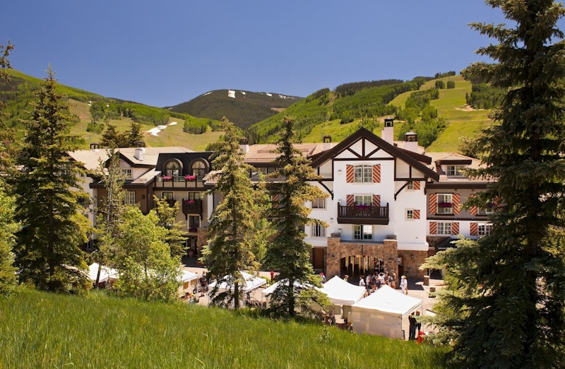 Vail condo rental European style building with lush green mountains in the background. Vail Village