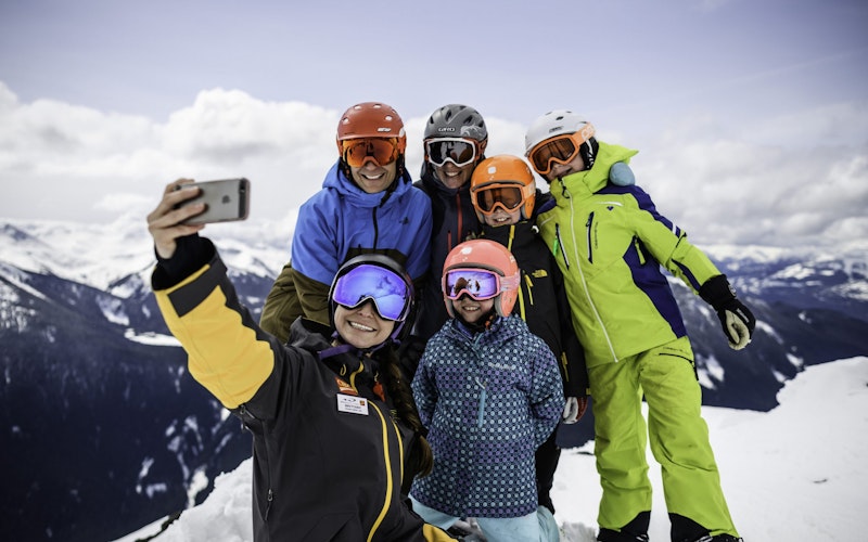 Family skiing with a Mountain Host in Whistler Blackcomb.