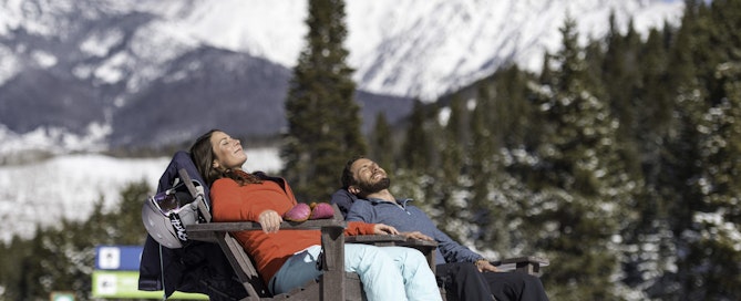 Couple relaxes at the top of the mountain in Vail, CO.