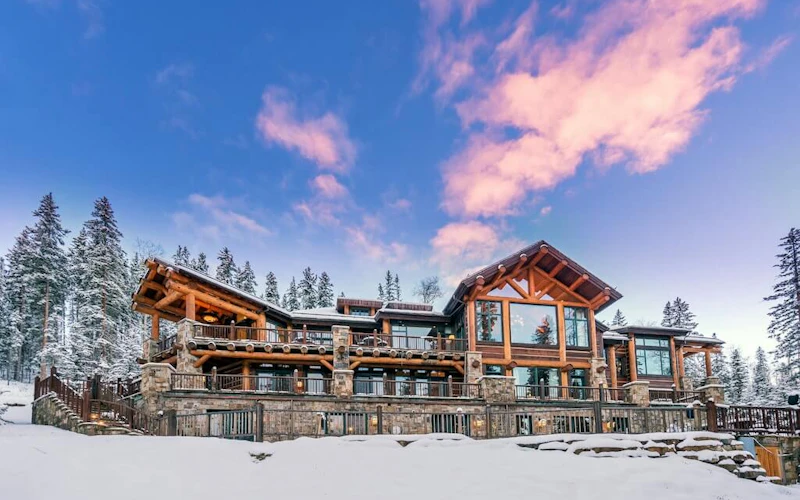Autumn Ridge luxury mountain lodge in Telluride’s Mountain Village with rustic timber architecture, snowy landscape, and panoramic alpine views.