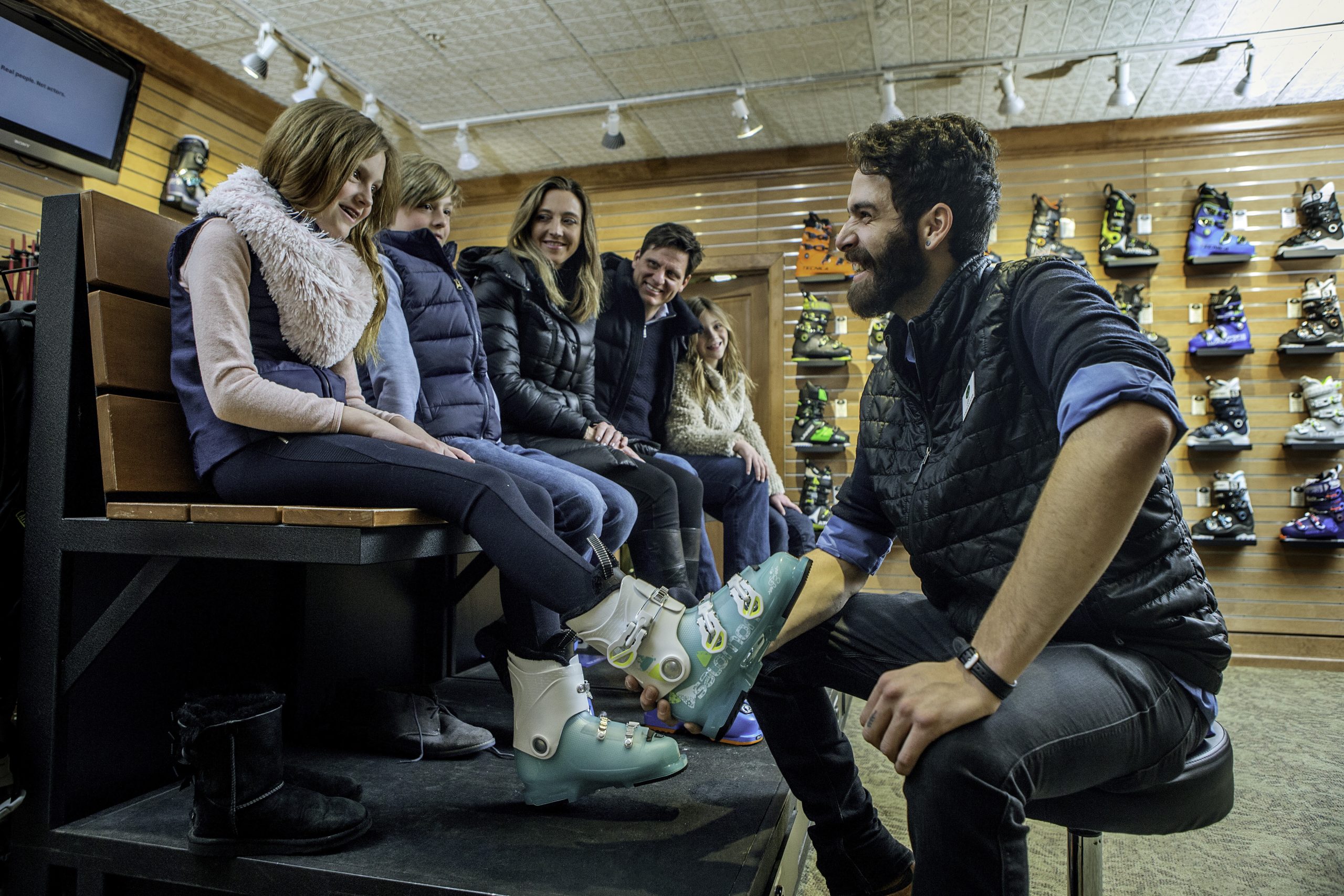 A family being fitted for ski boots at a Beaver Creek equipment rental shop