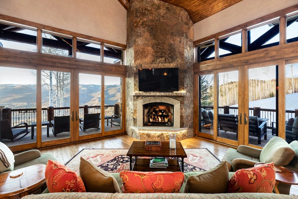 Cozy mountain lodge living room with fireplace and views in Beaver Creek Colorado