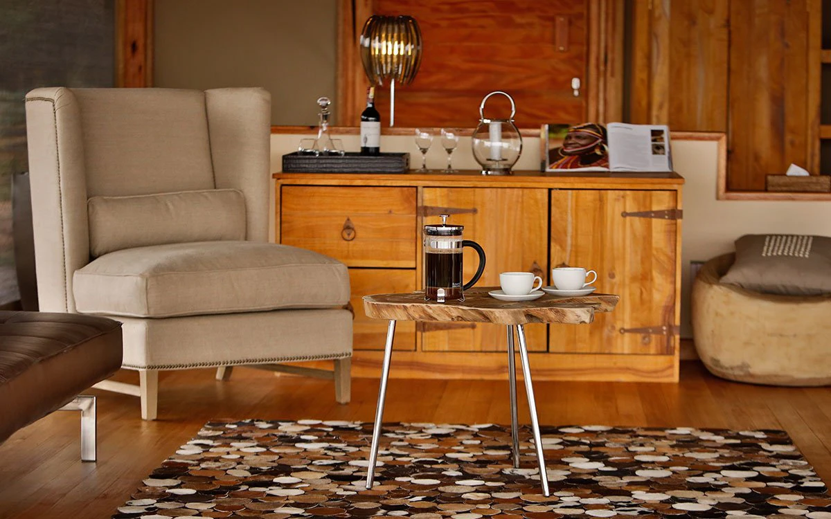 Internal view of the living area at Loisaba Tented Camp with an inviting chair and freshly made coffee on the table