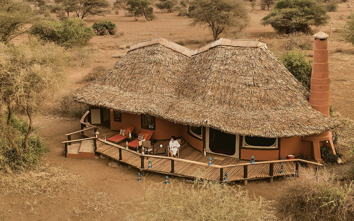 Aerial view of Tawi Lodge with guests enjoying the deck Aerial view of Tawi Lodge with guests enjoying the deck