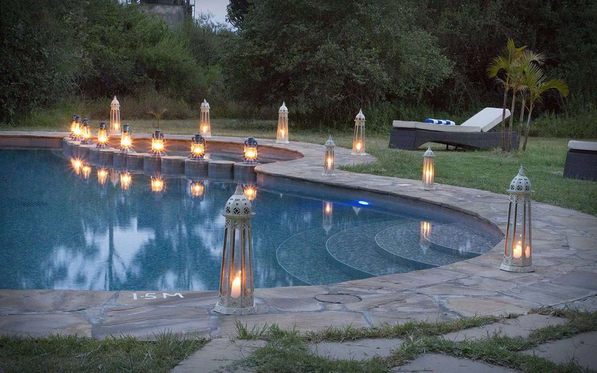 The swimming pool at Mbweha Camp lit up around the edges