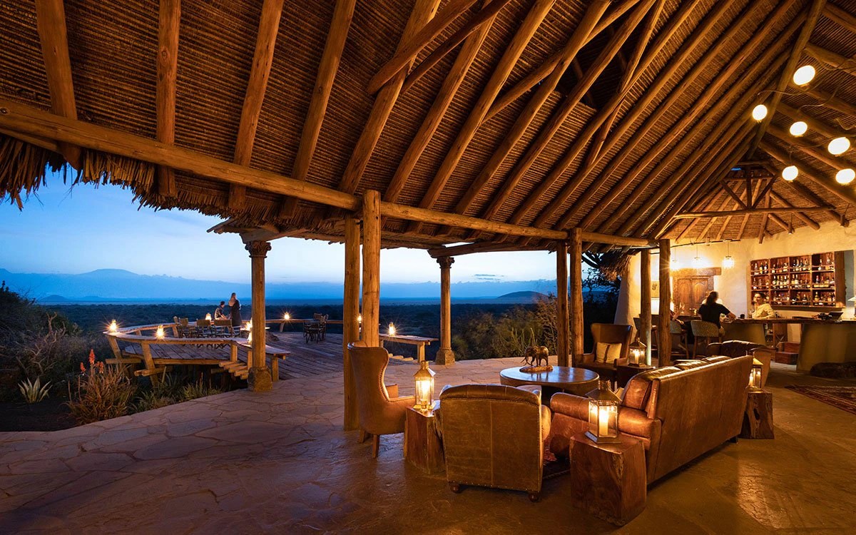 View from inside the stunning dining area at ol Donyo Lodge looking out to the deck just after sunset