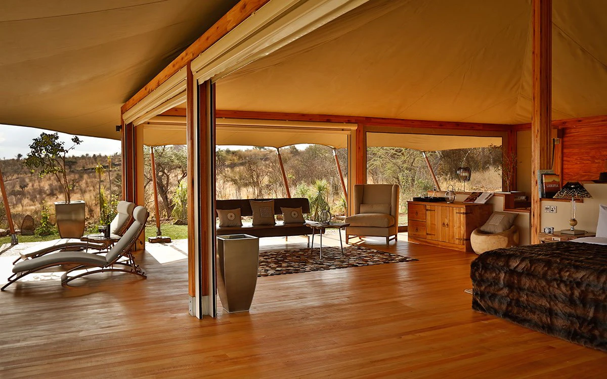 Wide angle interior view of the double tent at Loisaba Tented Camp