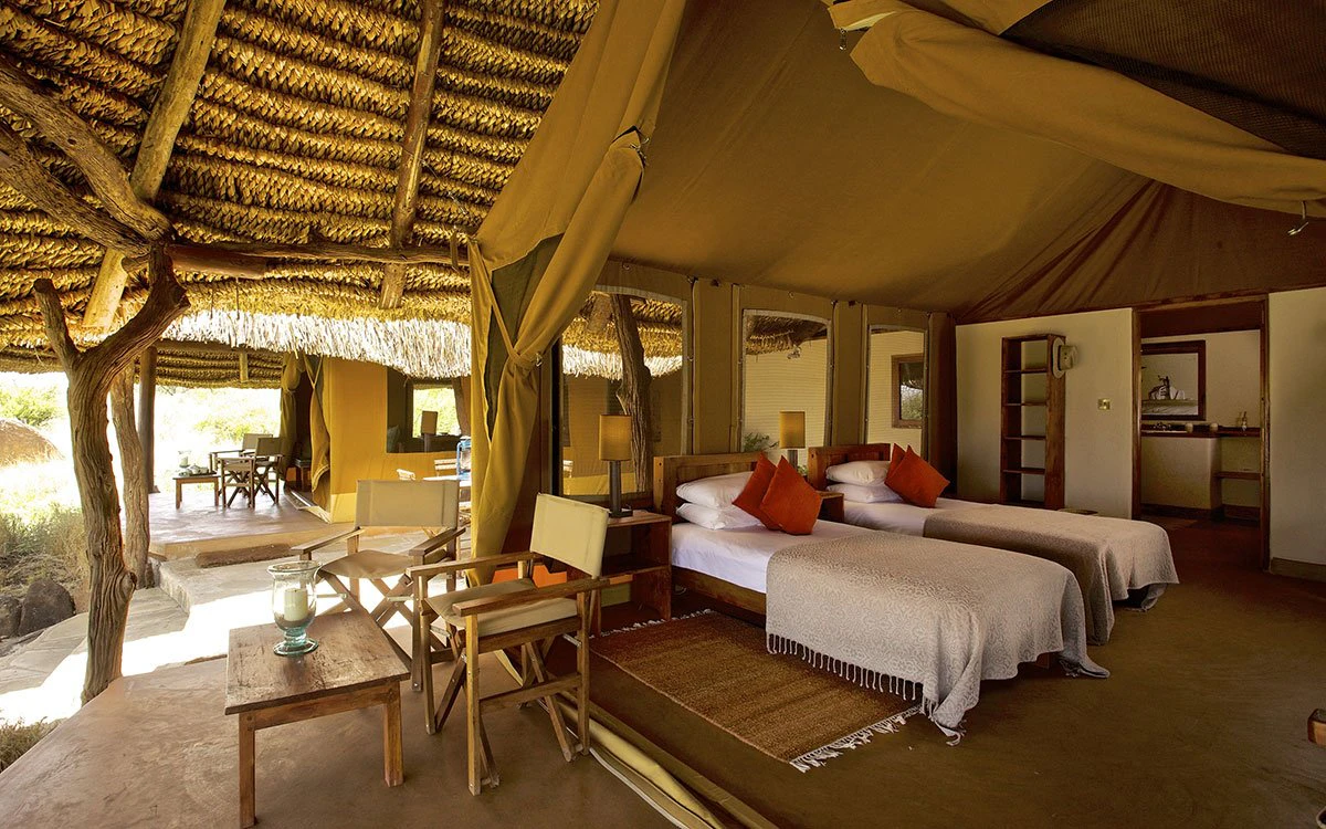Internal view of the twin room inside the family tent at Lewa with the private deck in the foreground