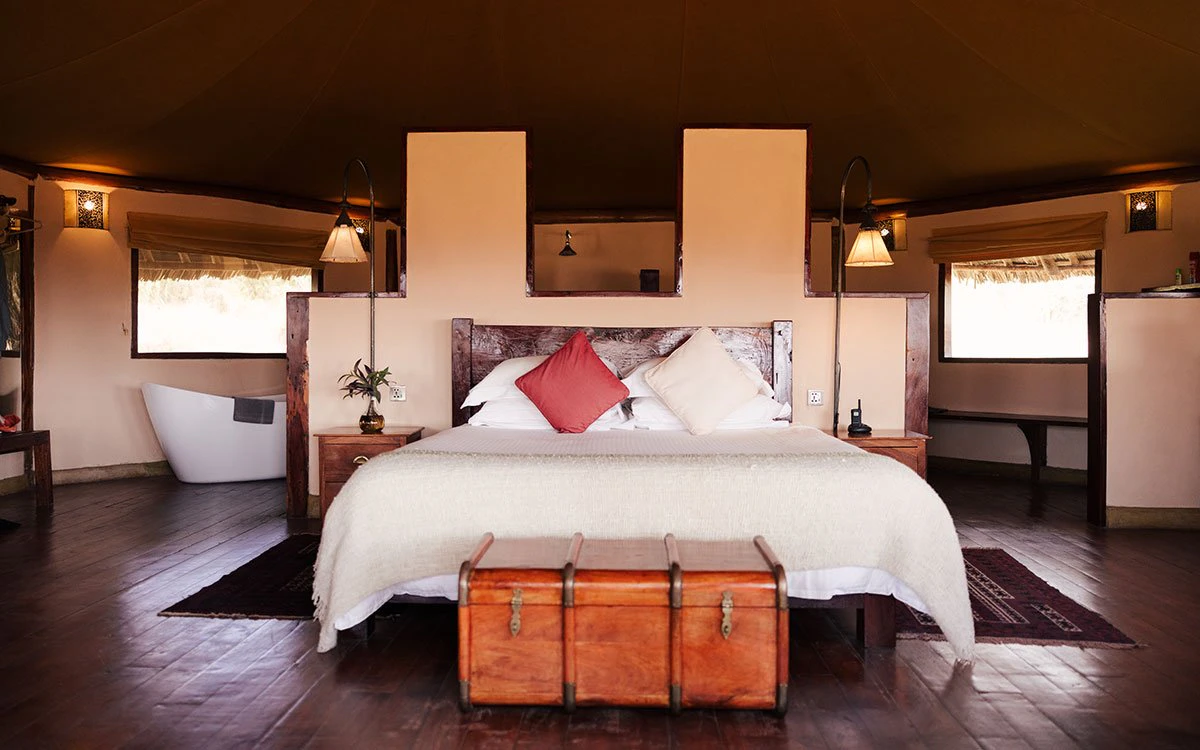 The bedroom and en suite bathroom in one of Tortilis Camp's tents