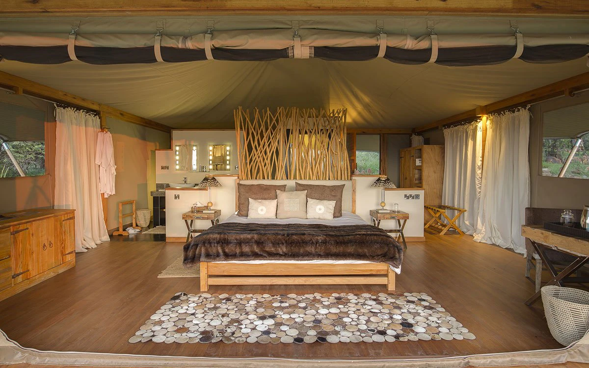 Interior image of the spacious double bed within a luxury tent at Loisaba Tented Camp