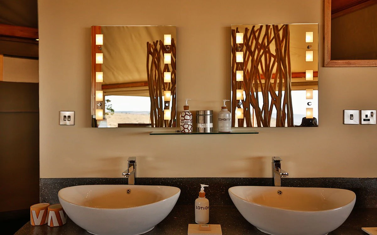 Interior shot of the double sinks in one of the ensuite bathrooms at Loisaba Tented Camp