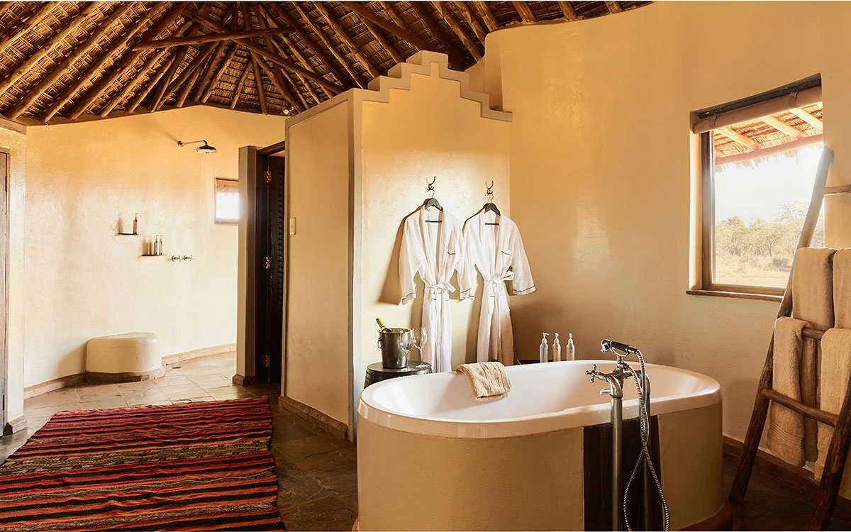 The tub and dressing gowns inside the sumptuous en suite bathroom in one of Tawi Lodge's bedrooms