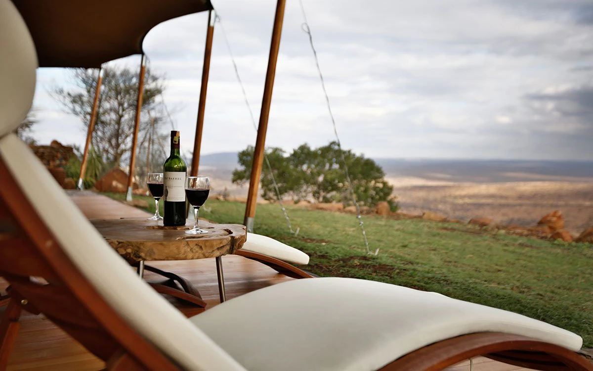 The view from the deck at Loisaba Tented Camp with a bottle of red wine waiting to be enjoyed