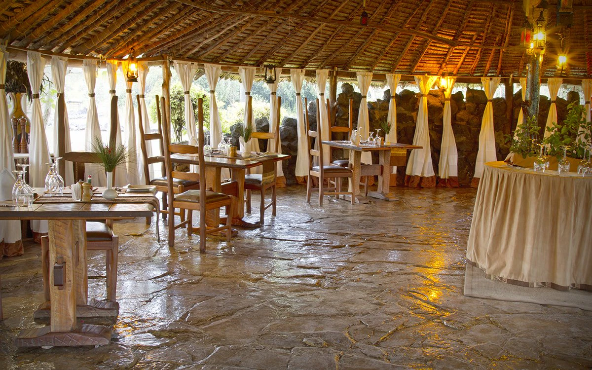 The dining room at Mbweha Camp with tables beautifully laid
