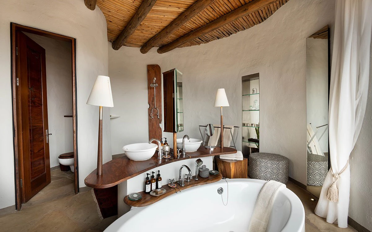 A luxurious en suite bathroom at ol Donyo Lodge where the tub and double sinks can be seen