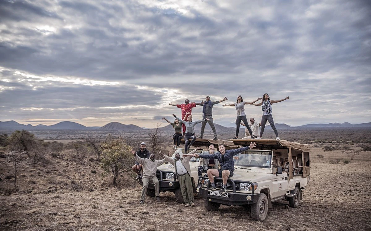 A group of Finch Hattons guests pose for a group photo during the game drive