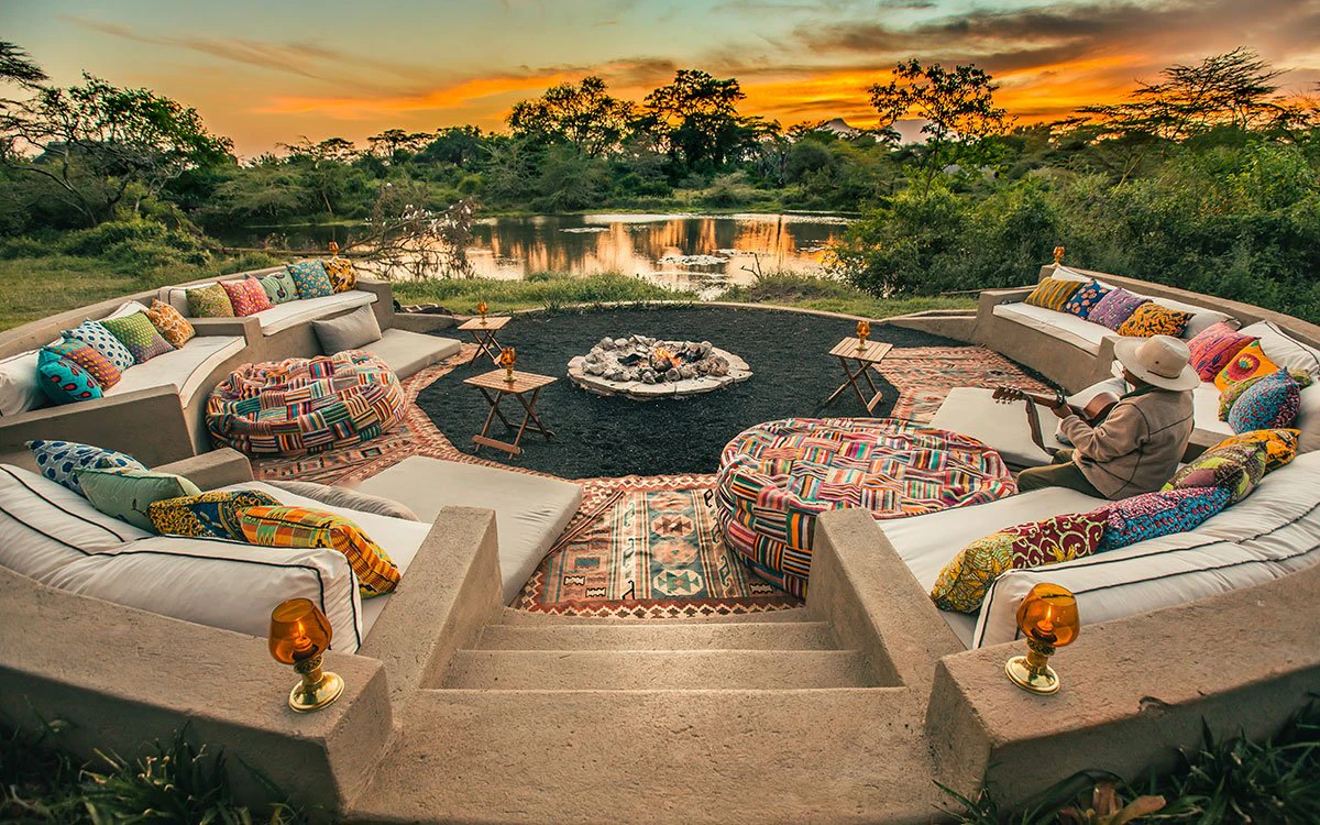Exterior shot of the Boma at Finch Hattons with its large seating area with a beautiful sunset in the background