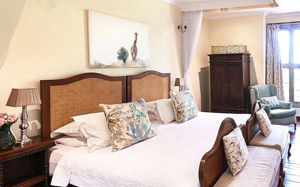 A luxurious double bed in one of the suites at Giraffe Manor