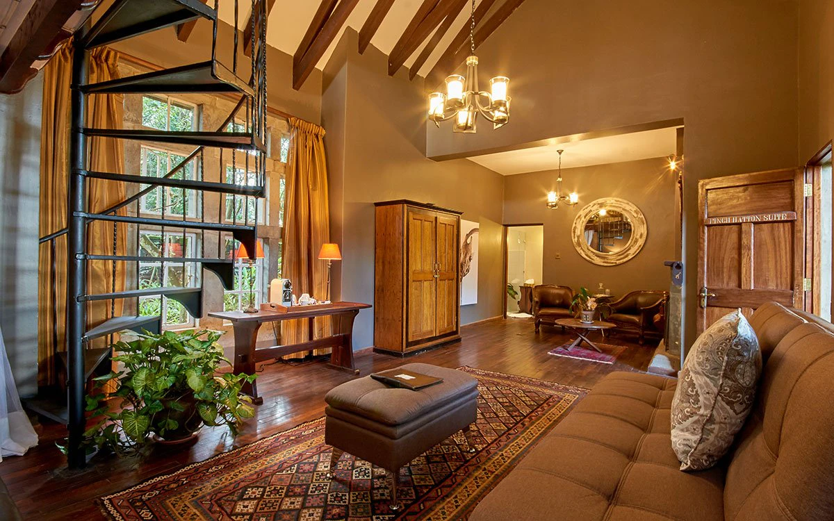 The living area and spiral staircase at the Finch Hatton suite at Giraffe Manor