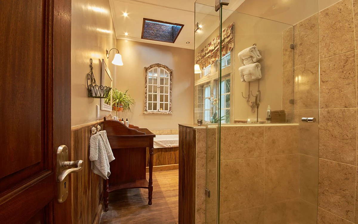 An en suite bathroom at Giraffe Manor showing the shower and bath tub