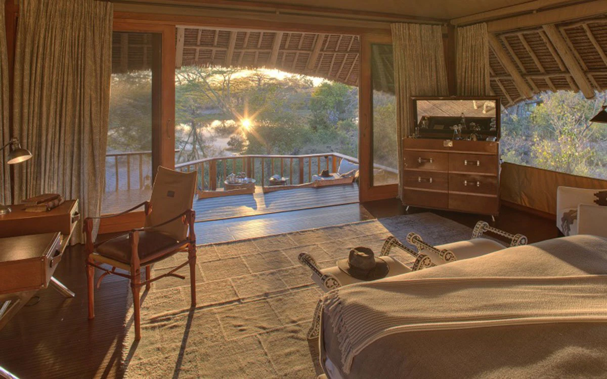 View from inside the tented suite at Finch Hattons showing the private balcony at sunrise