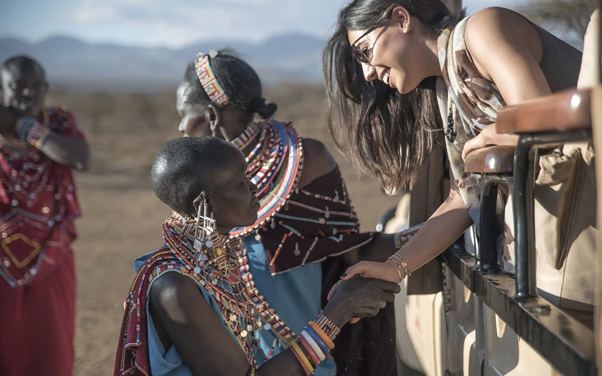 Members of a Maasai village greet a group of Finch Hattons guests during a community visit