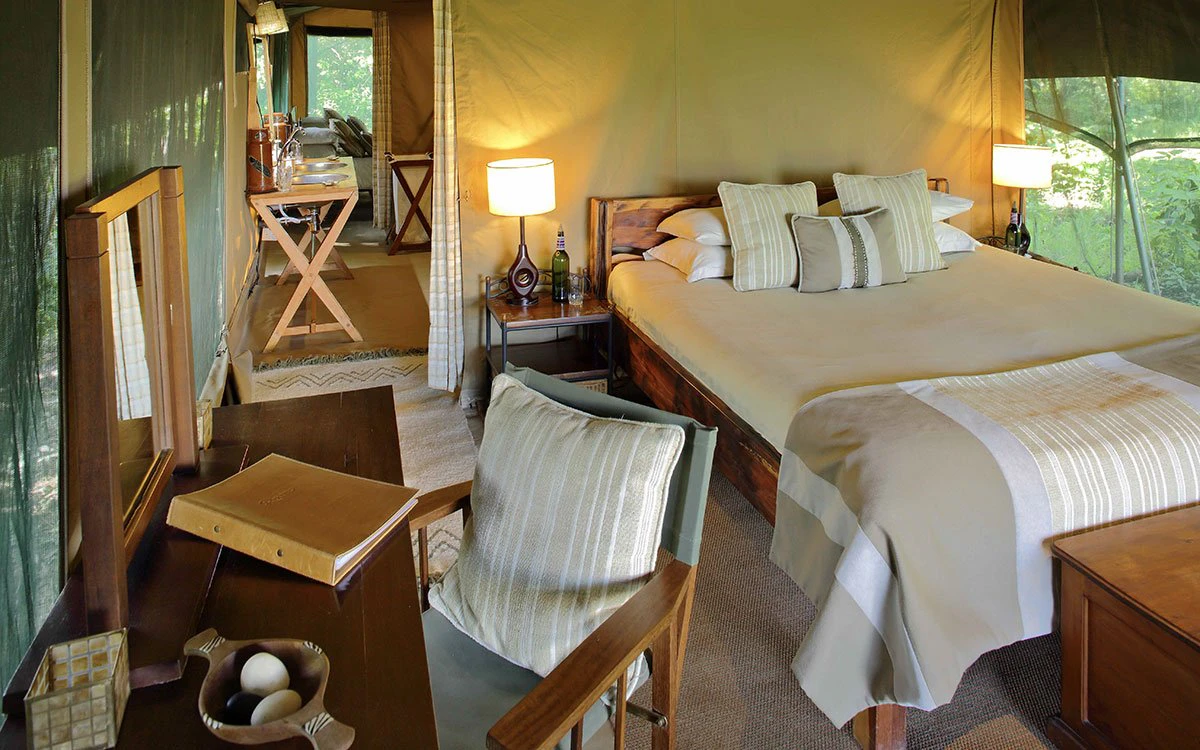 The master bedroom in the family tent at Rekero Camp with a beautifully made bed