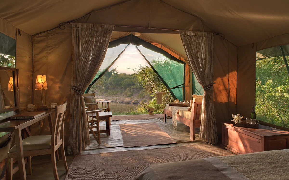 Interior view from inside one of the guest tents at Rekero Camp at sunset