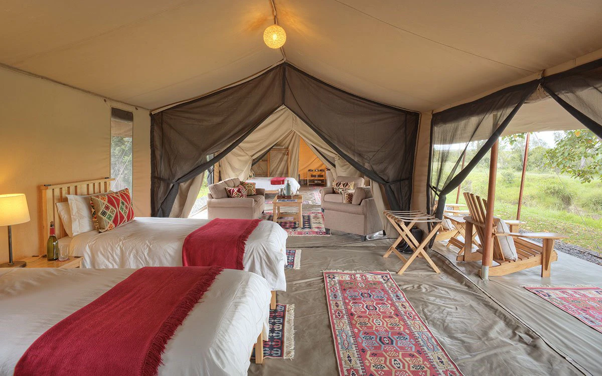 Internal view of a bedroom and the living space inside the family room at Ol Pejeta