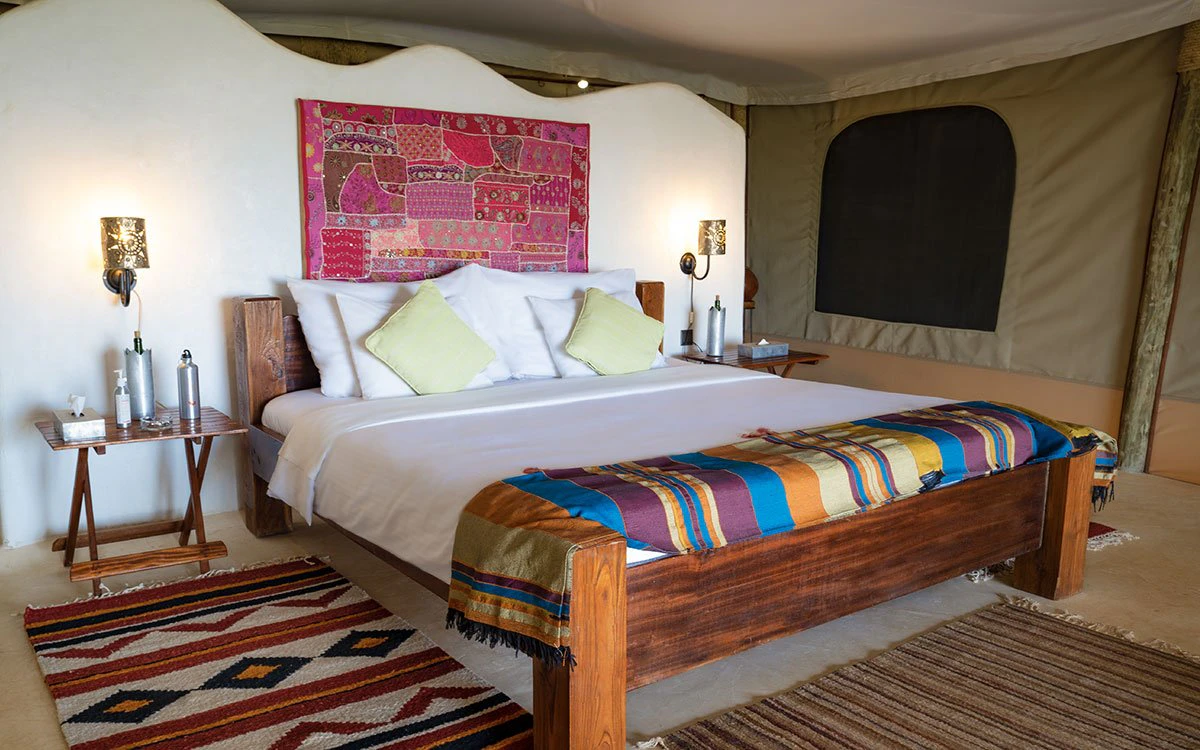 A bedroom in the Rock Suite at Kipalo Hills showing a inviting, freshly made bed