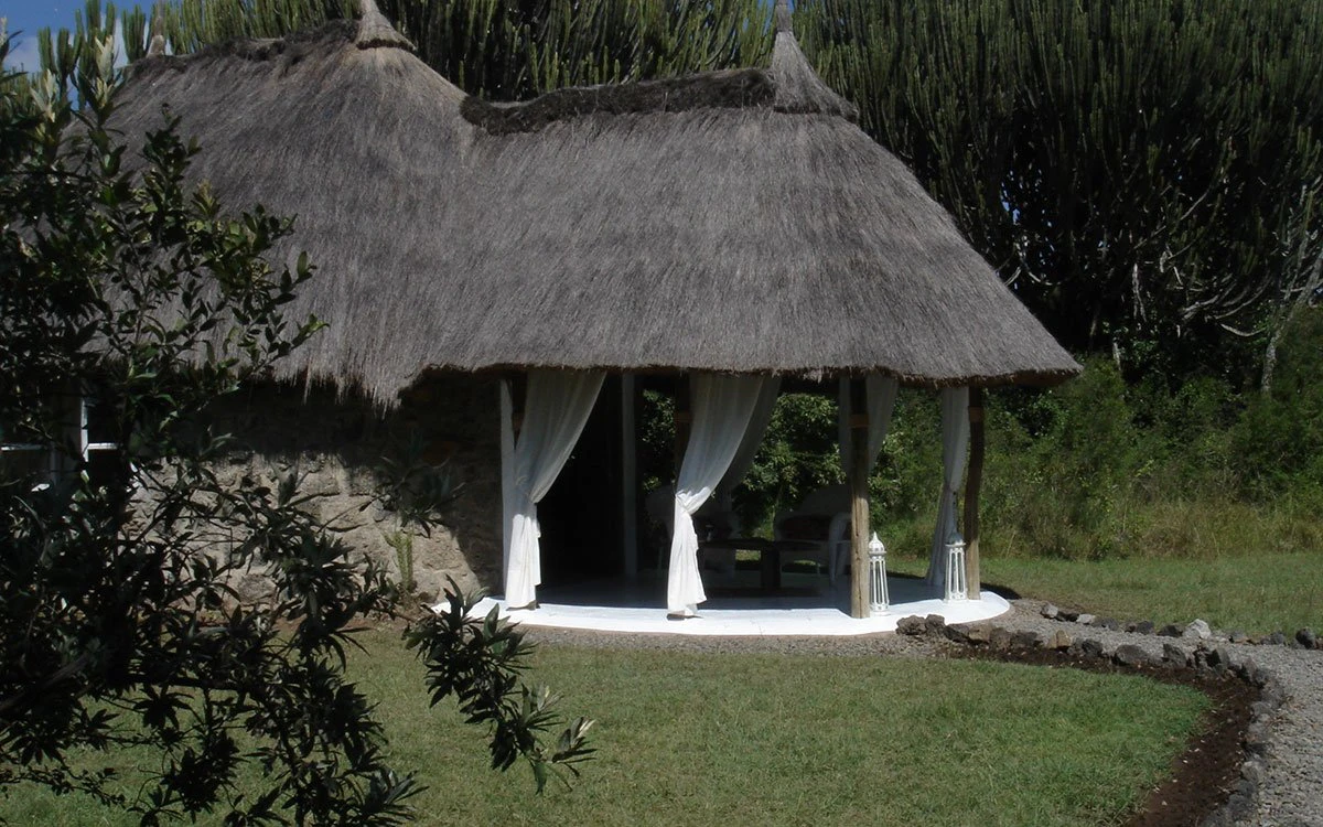 External view of Mbweha Camp near Lake Nakuru showcasing its signature thatch roof