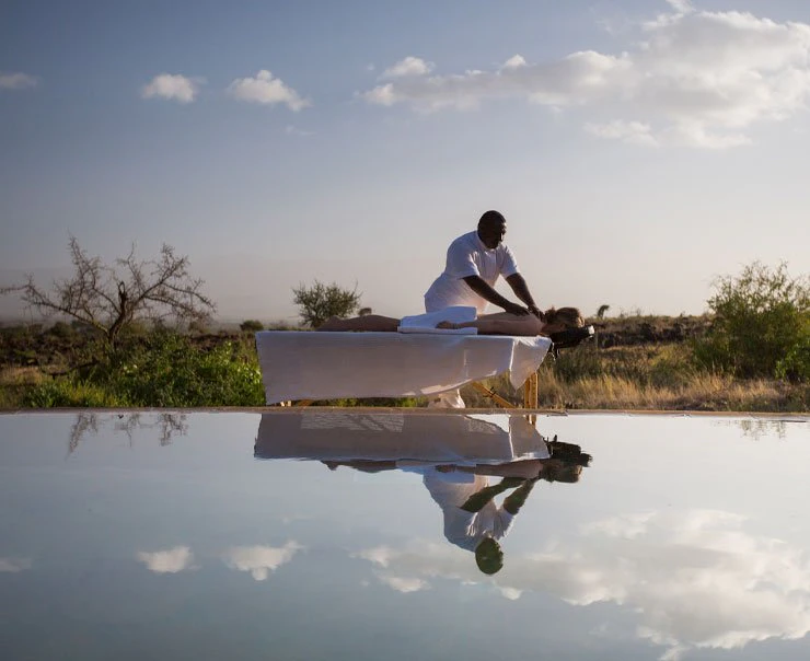 A guest enjoys a relaxing massage whilst on safari
