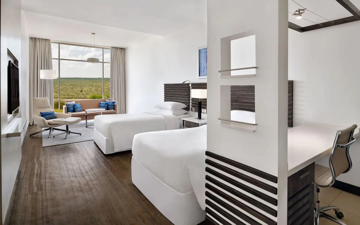 Interior image of a twin suite at the Sheraton showing both beds