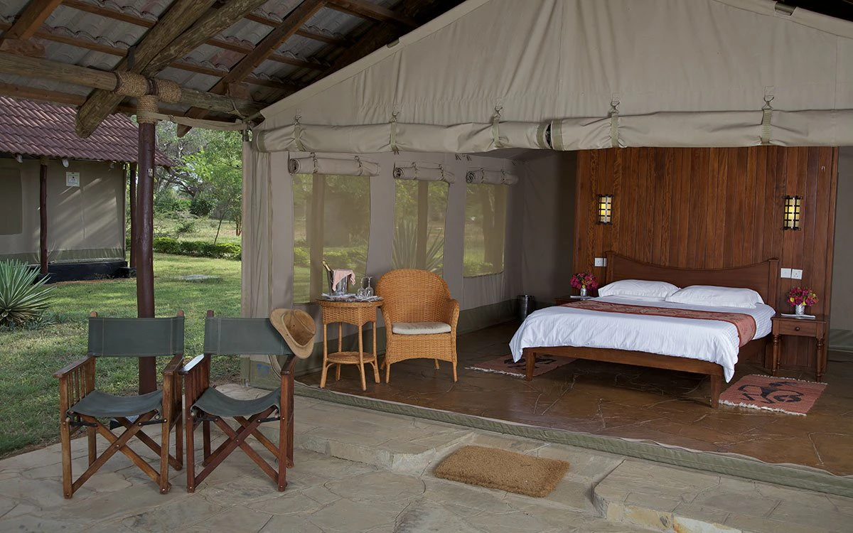 View of a tented room at Ashnil Aruba showing the bedroom and the private balcony