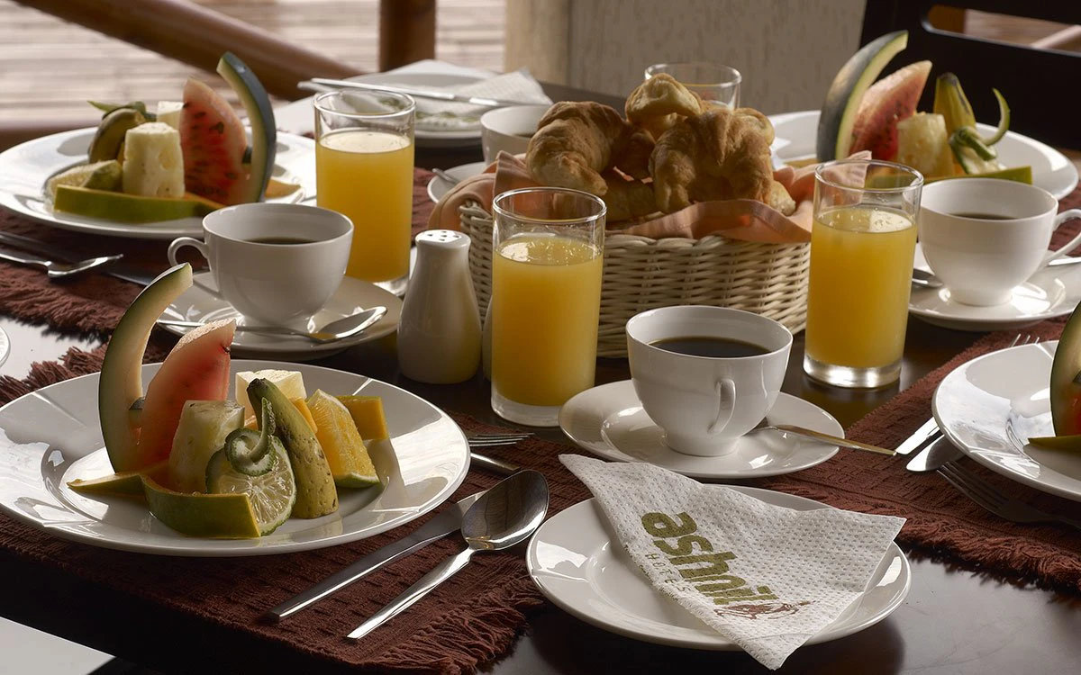 A delicious breakfast is served at Ashnil Aruba featuring coffee and fresh fruit