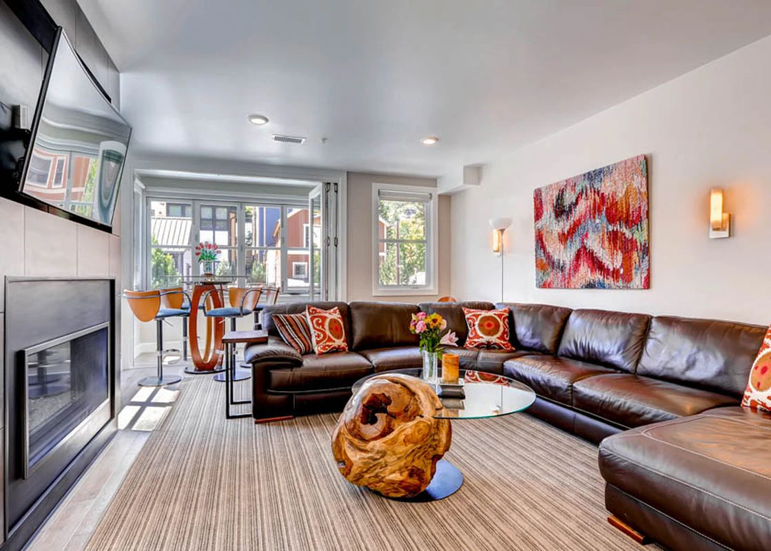 Interior image of the living room at Rio Grande, with a large TV and leather sofa.