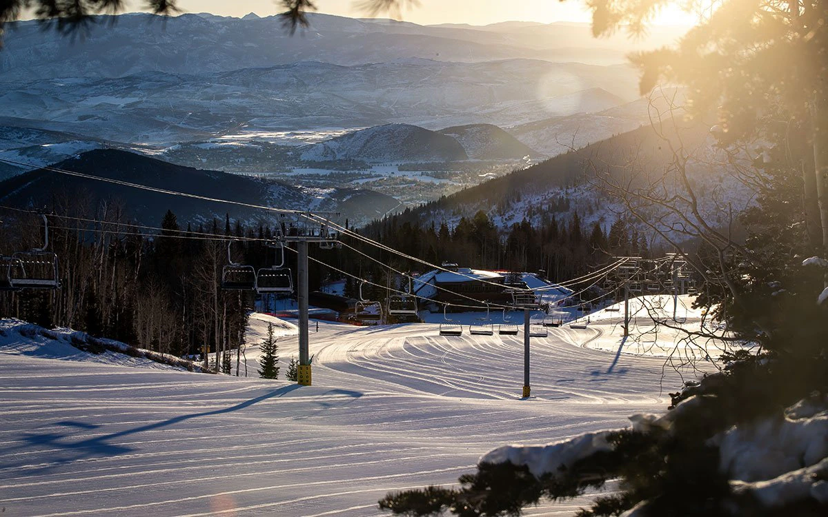 A group of skiers carrying their rental gear to the chair lift in Park City.
