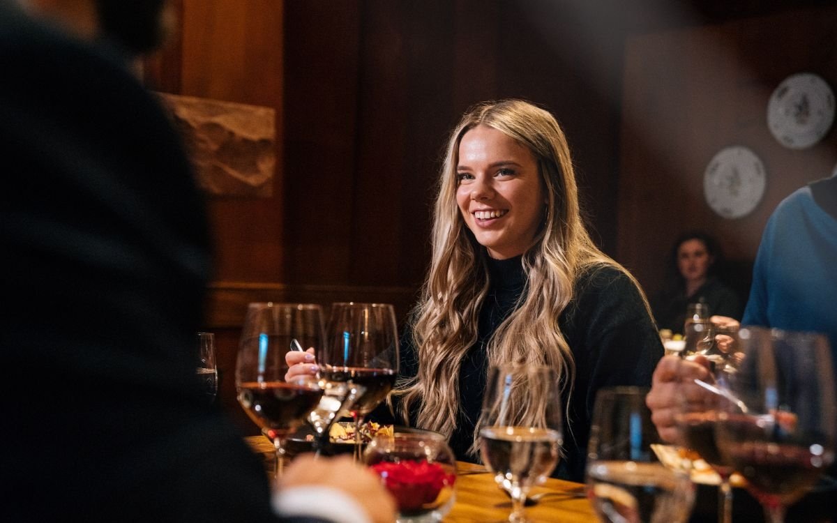 A female diner enjoys a delightful dinner at Fireside Dining.