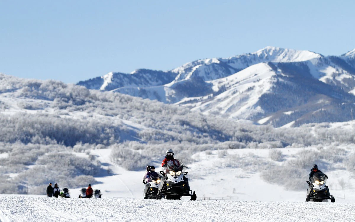 A group of Deer Valley guests enjoy a day out snowmobiling during the winter months.