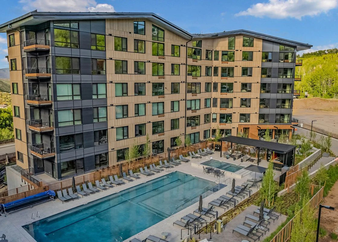 Back exterior of Electric Pass Lodge in Aspen Snowmass showcasing the luxurious pool area.