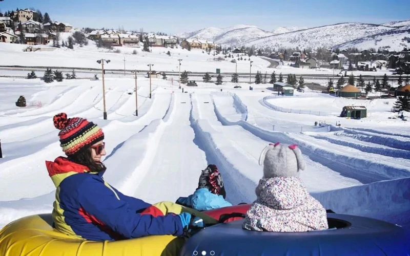 A mother and daughter enjoy tubing at Woodward Park. A mother and daughter enjoy tubing at Woodward Park.