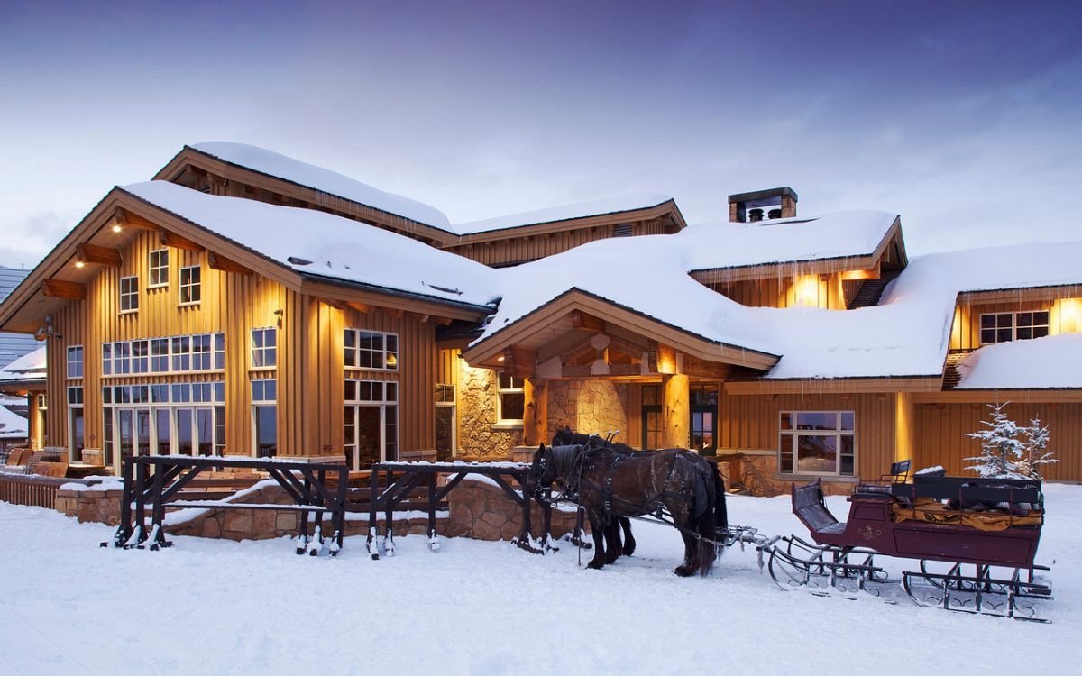 A horse-drawn sleigh waits patiently to welcome guests at dusk in Deer Valley.