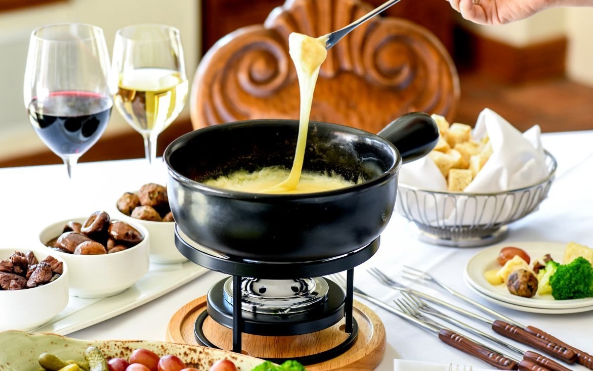 A delicious fondu being shared at Deer Valley with wine served in the background.