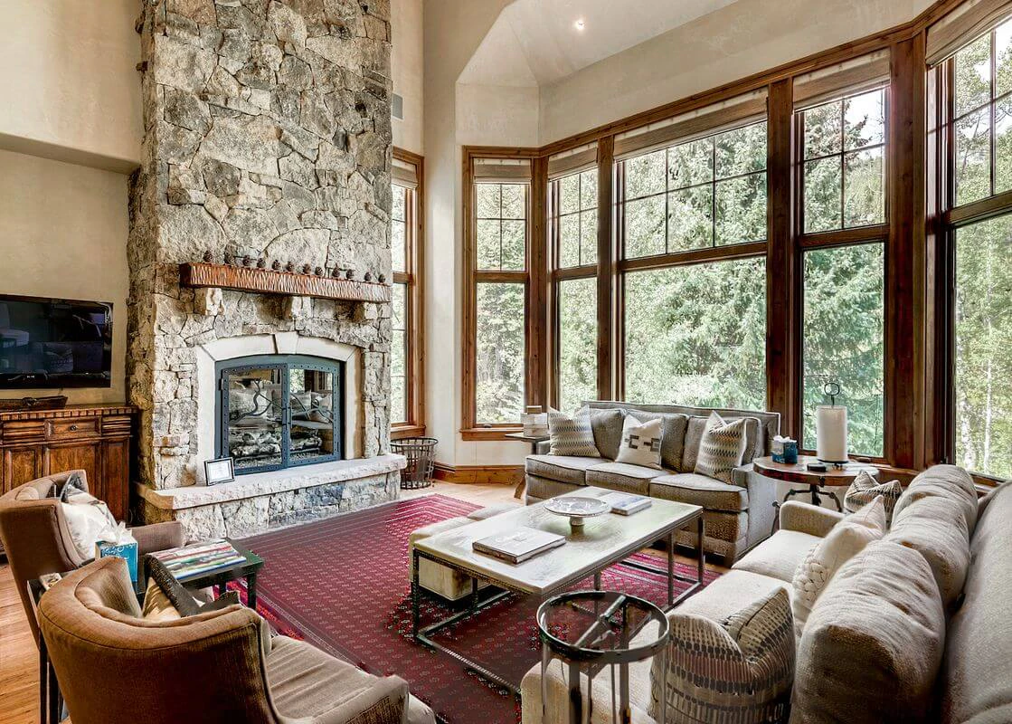 Spacious living room with stone fireplace at 115 Village Walk luxury rental in Beaver Creek Village.
