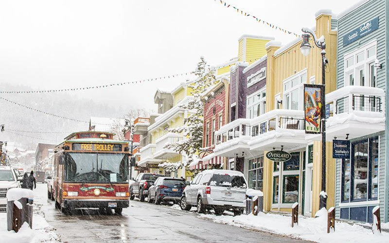 Snowy street in Park City near Deer Valley luxury rentals with shuttle access and private SUV transfers available. Snowy street in Park City near Deer Valley luxury rentals with shuttle access and private SUV transfers available.