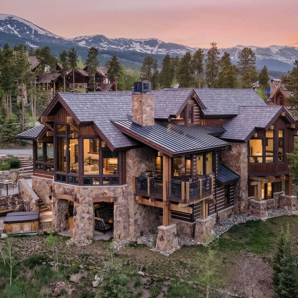 Epic Retreat, a stunning mountain home in Breckenridge, framed by pine forest and alpenglow skies—an exceptional example of Breckenridge luxury rentals.