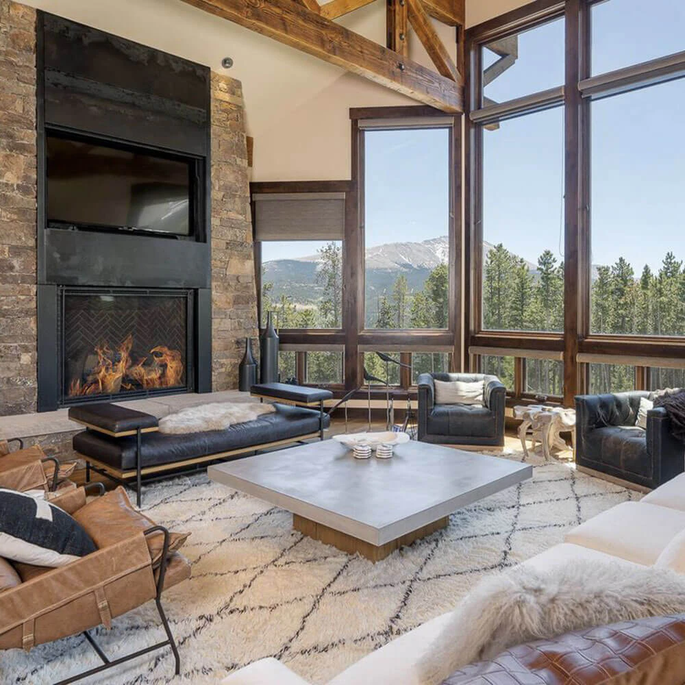 Elegant mountain living room at Epic Retreat in Breckenridge featuring floor-to-ceiling windows, roaring fireplace, and alpine views—an exceptional example of Breckenridge luxury rentals. Elegant mountain living room at Epic Retreat in Breckenridge featuring floor-to-ceiling windows, roaring fireplace, and alpine views—an exceptional example of Breckenridge luxury rentals.